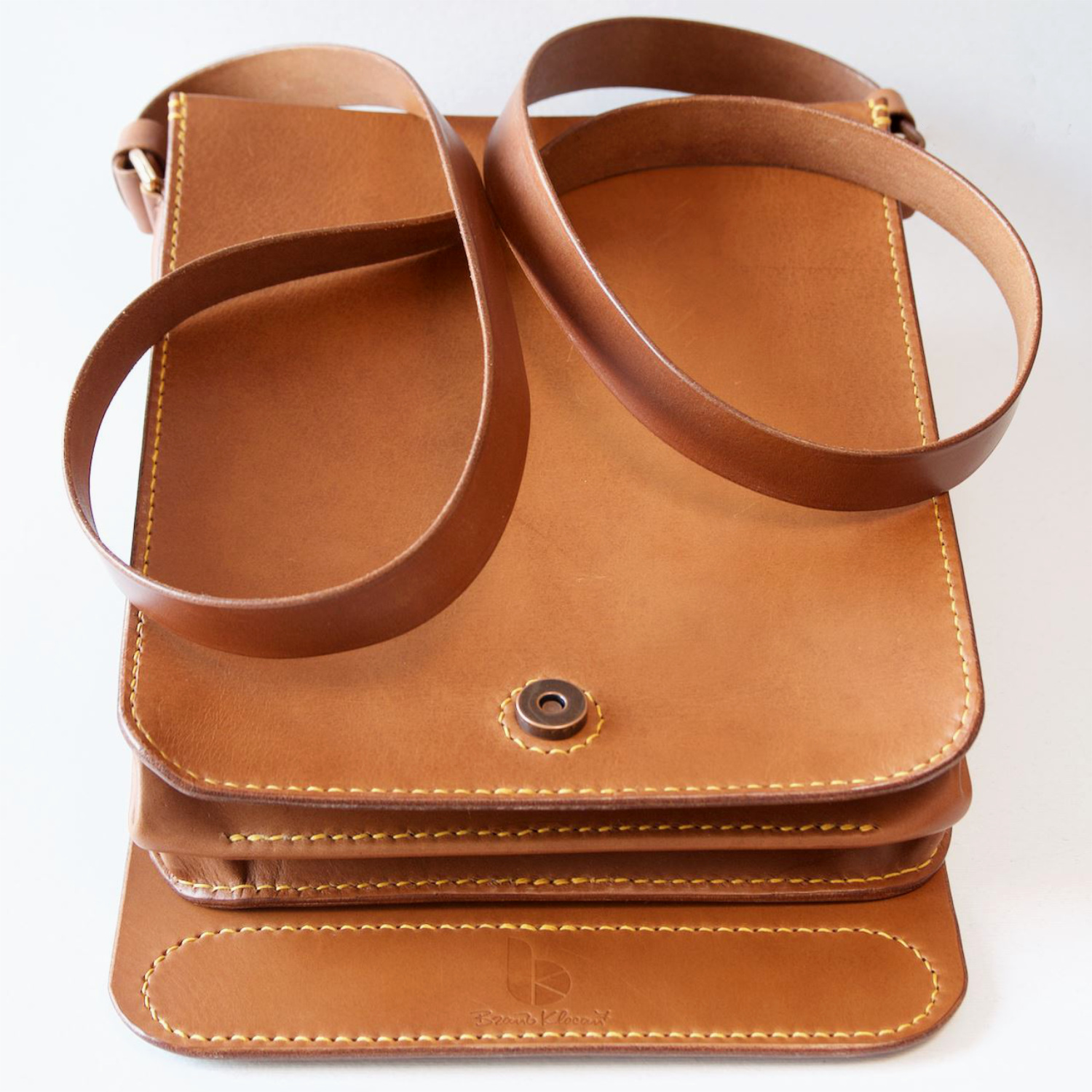 leather messenger bag with cover all flap closure detail