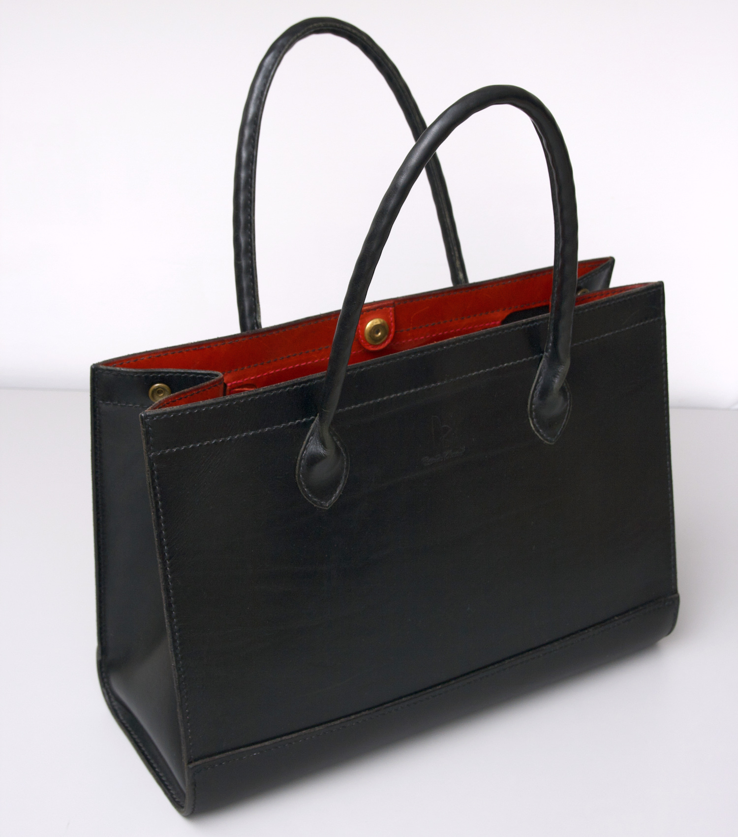 opened leather tote bag with round handles 