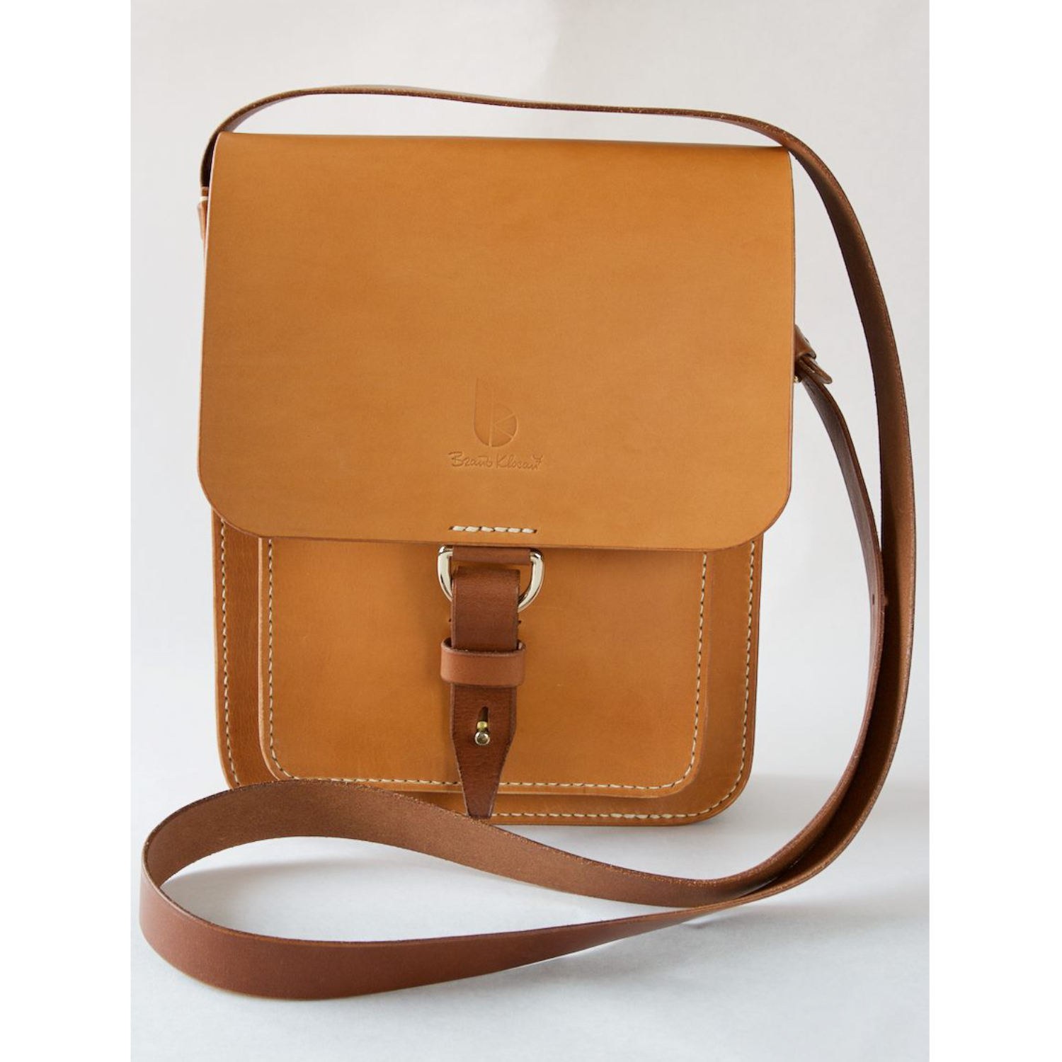 leather messenger bag with strap and dring closure front view