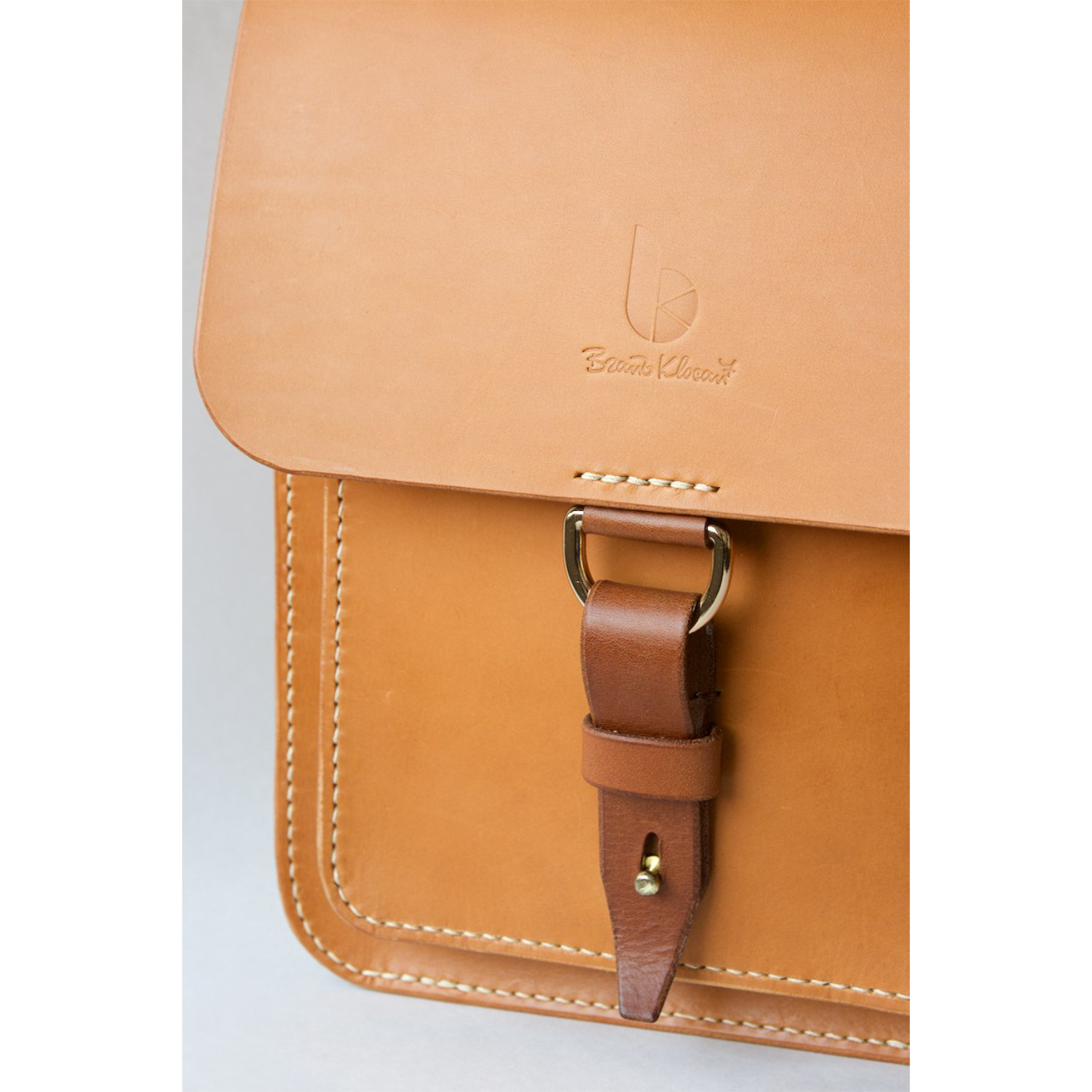 leather messenger bag with strap and dring closure detail